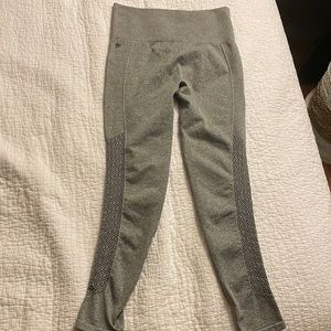 Grey Fabletics leggings with leg design. Size Small. Never worn.
